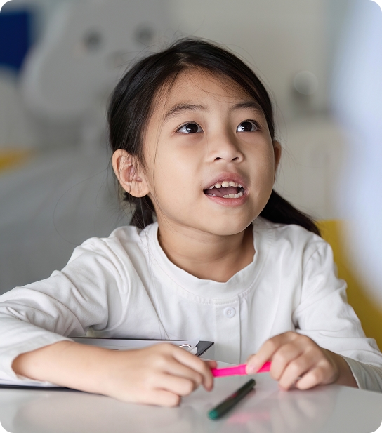 School-age child smiling at a dental checkup