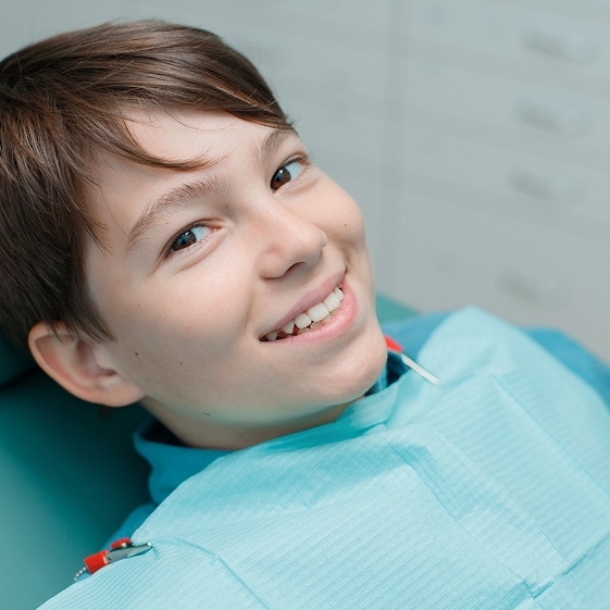 Dentist treating a child during a dental crown visit
