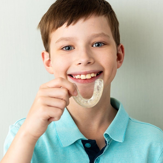 Dentist showing a child their bite in the mirror