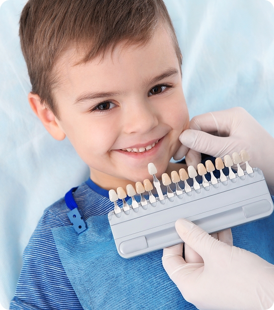 Young child smiling and showing healthy teeth