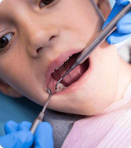 Young child smiling and showing healthy teeth
