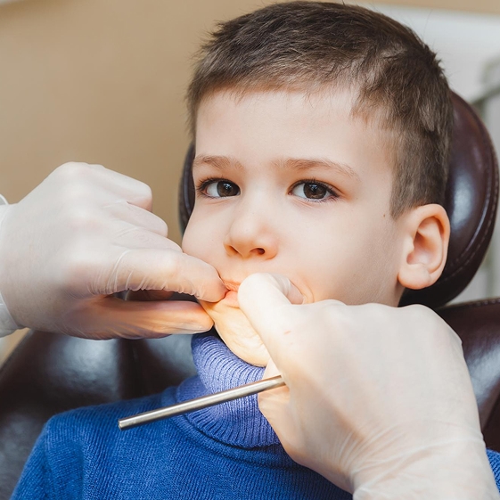 Dentist teaching a child about dental care