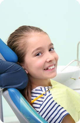 A child smiling and showing healthy teeth