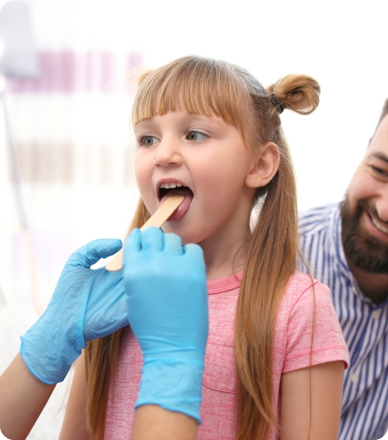 Young child smiling and showing healthy teeth