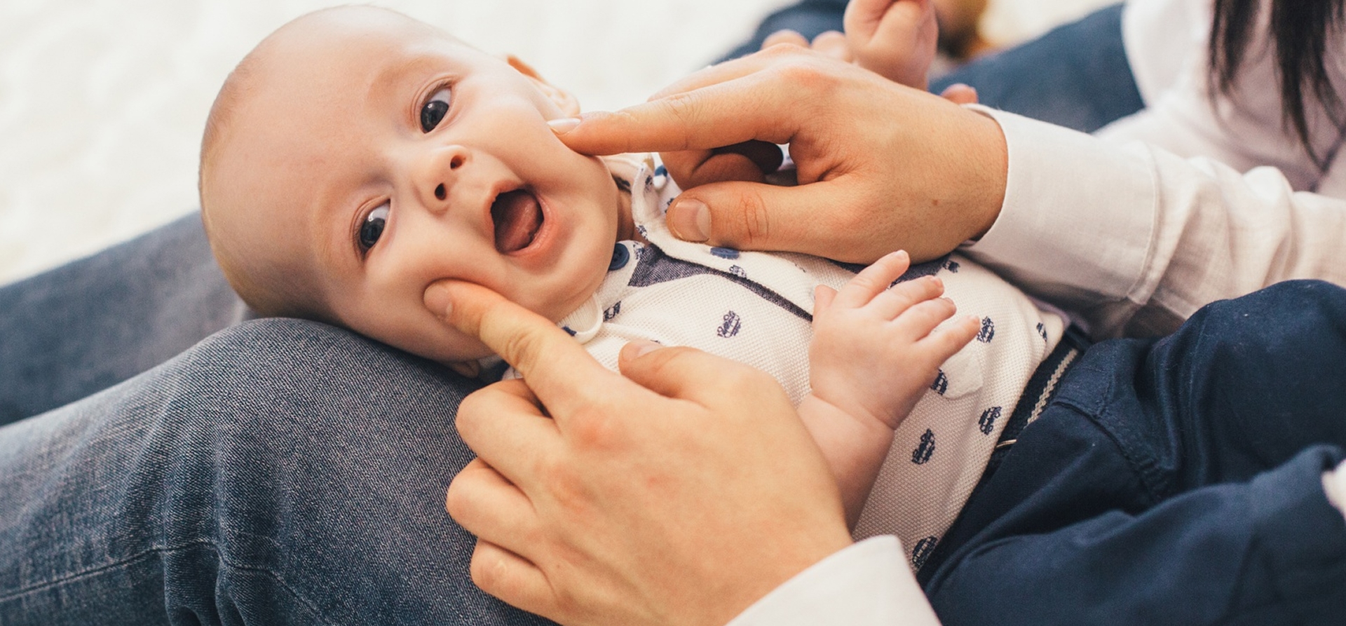 Parent and pediatric dentist talking through infant care