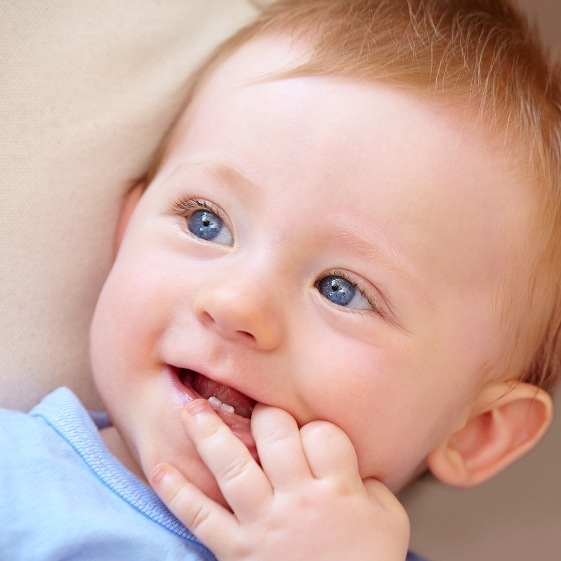 Parent holding an infant at a dental appointment
