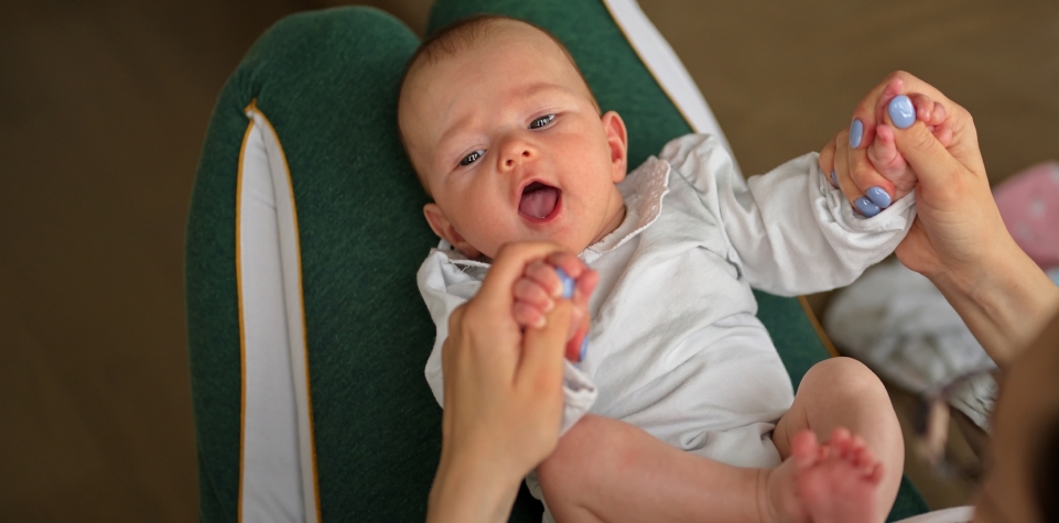 Parent feeding an infant