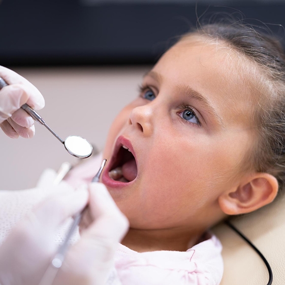 Dentist teaching a child about dental care