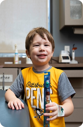 A child smiling during a pediatric dental appointment
